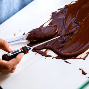 Checking the temperature of the liquid chocolate
