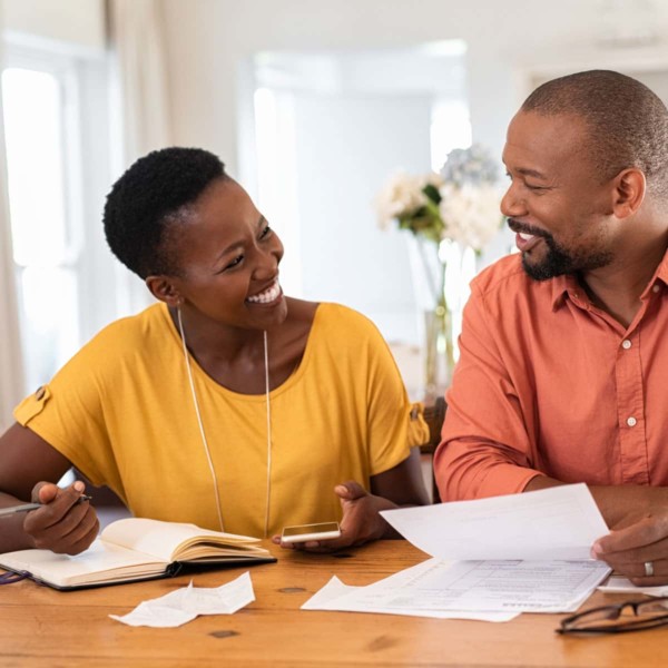 Couple looking through papers to check their spending