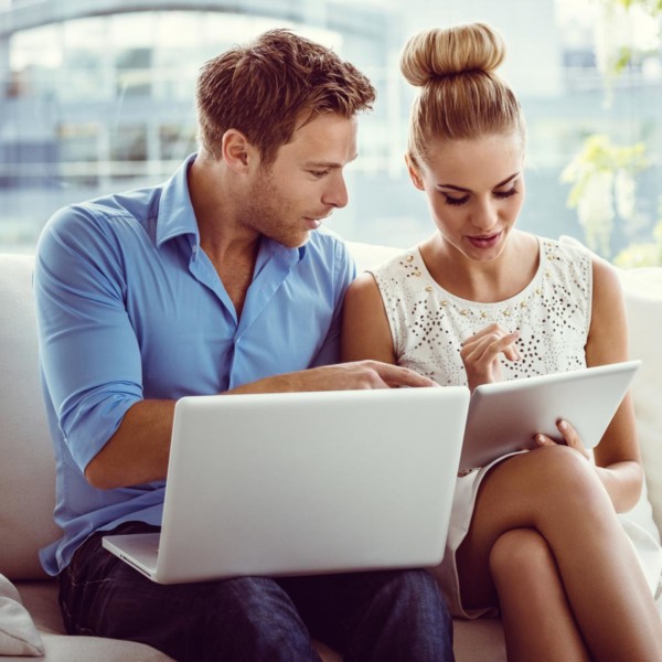 couple sitting on couple looking at charities to donate to