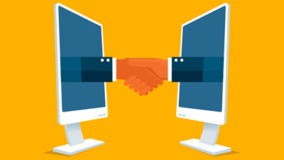 Hands shaking and making a deal through their computers