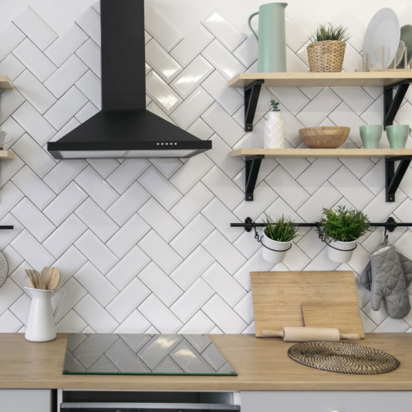 kitchen with floating shelves with green decor accents