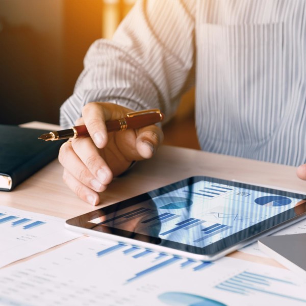 man sitting at his desk evaluating spreadsheets