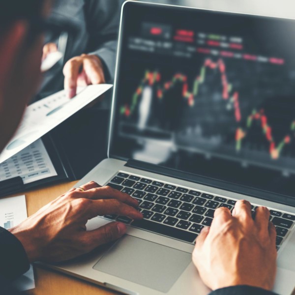 Man looking at investments over time on a laptop