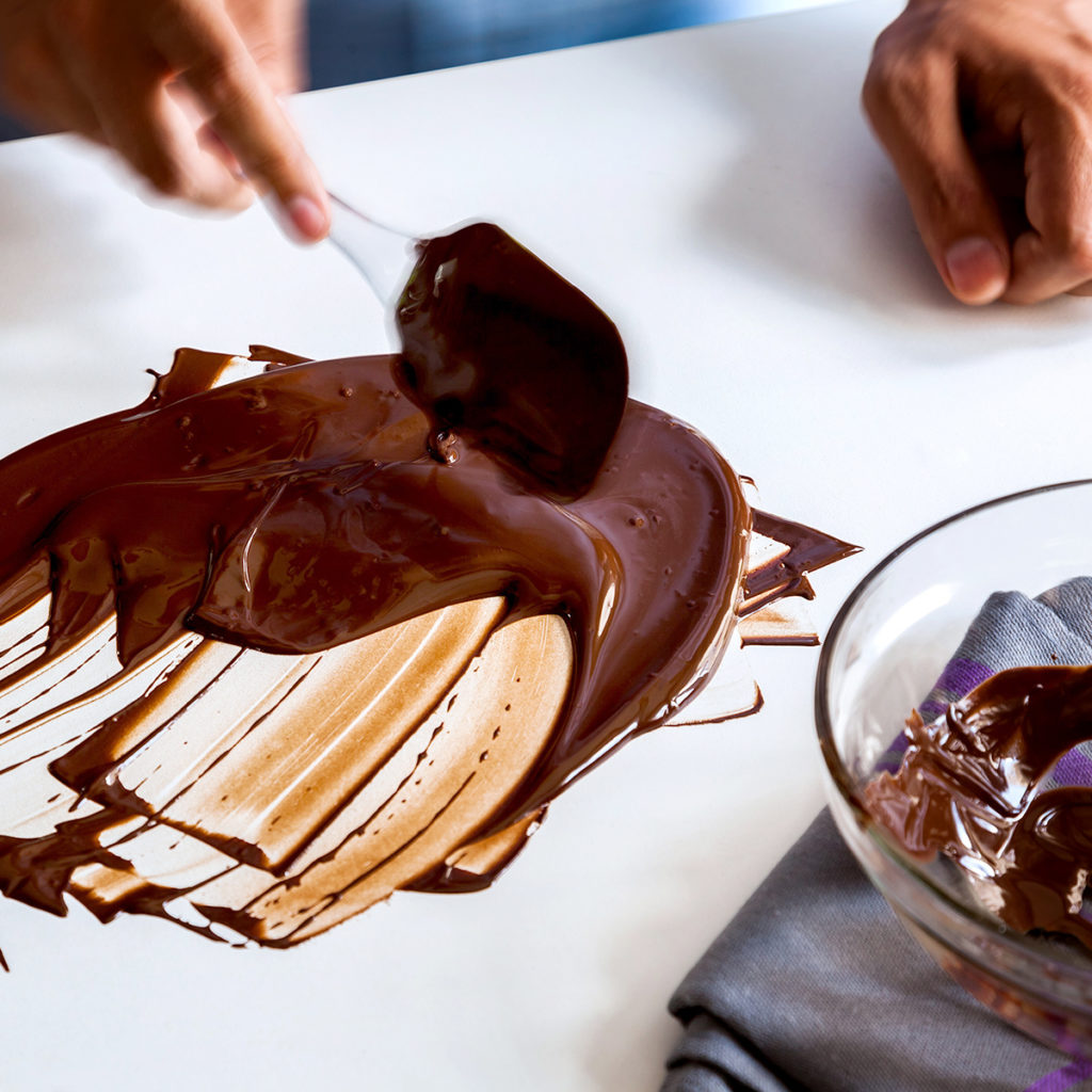Moving liquid chocolate around on table