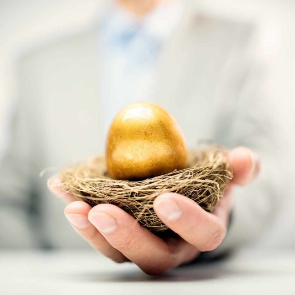 man holding a golden egg in a nest