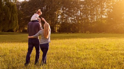 Image of a family walking through a field.
