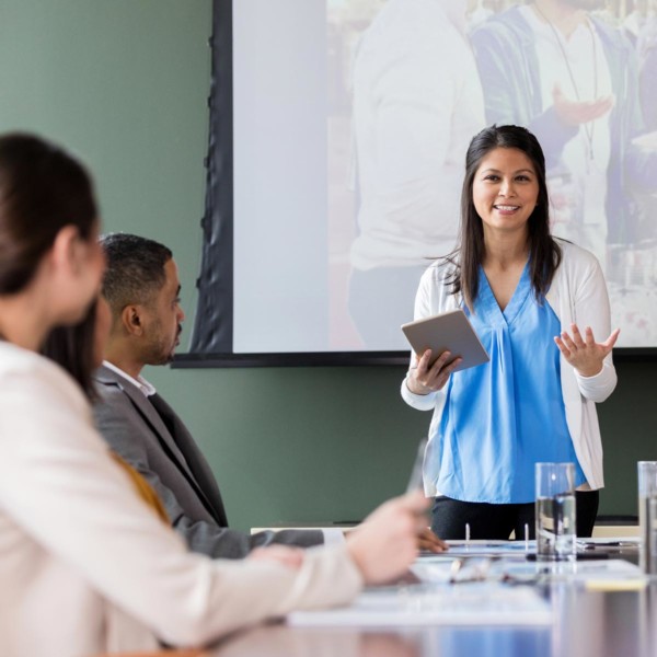 women discussing volunteering with her peers at work
