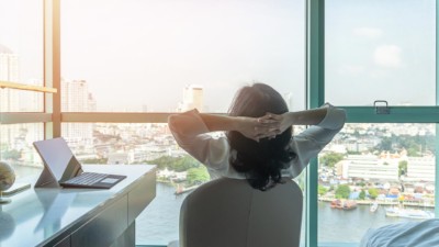 women sitting at a desk looking at a view happy