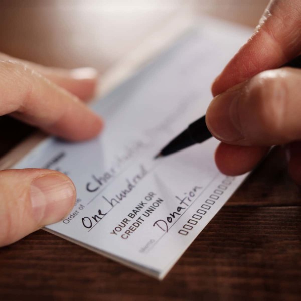 zoomed in image of person writing a check