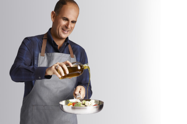 Marcus cooking with olive oil
