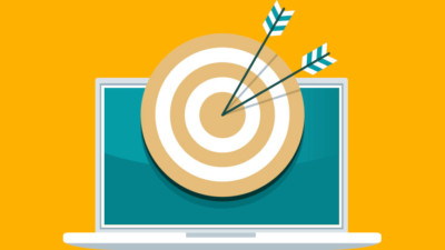 Image of a laptop with a bullseye on it with arrows.