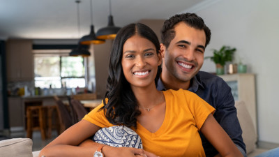 Image of a couple sitting on the couch.