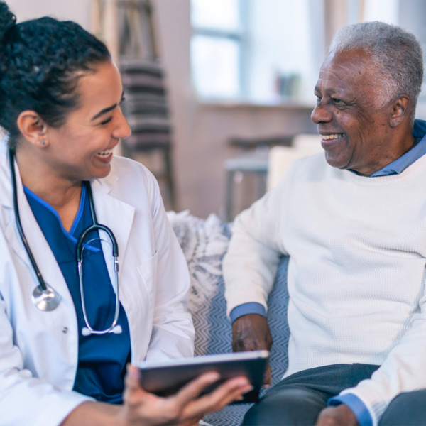 Doctor looking at charts with patient smiling