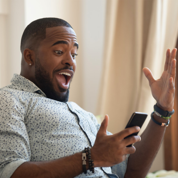 Man receiving good news from cell phone