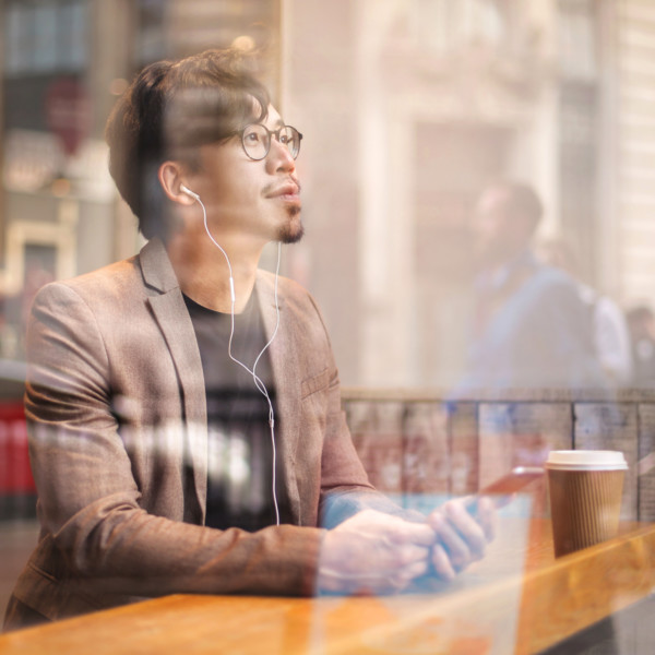 Man looking out the window at a coffee shop
