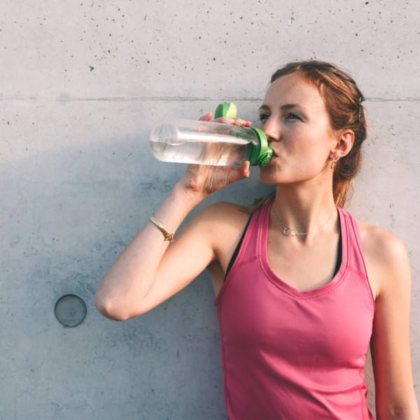 Woman drinking water after workout