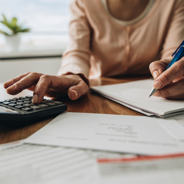 woman making calculations to help manage debt