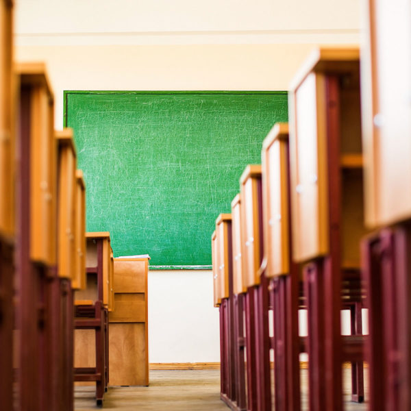 Image of desks in classroom to symbolize learning how to pay taxes