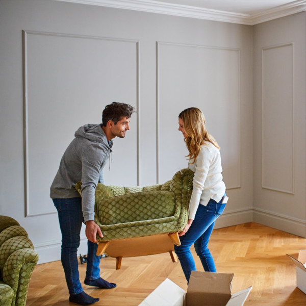 Image of man and women moving a green chair