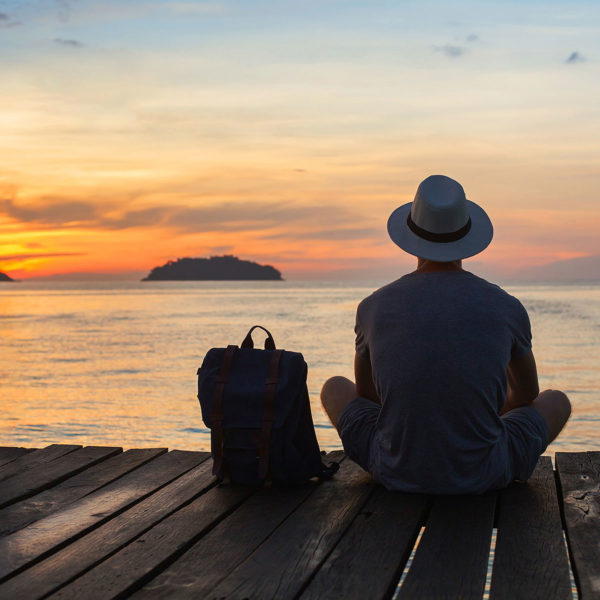 Image of someone sitting looking out at the ocean