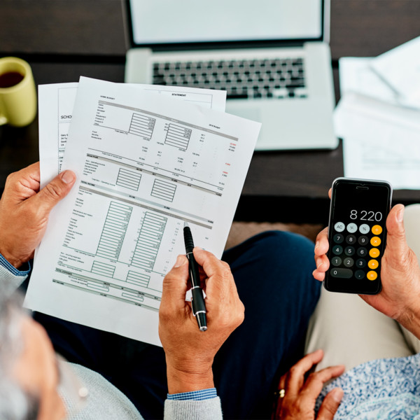 Image of man holding financial reports