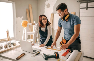 Image of man and women remodeling a home under construction