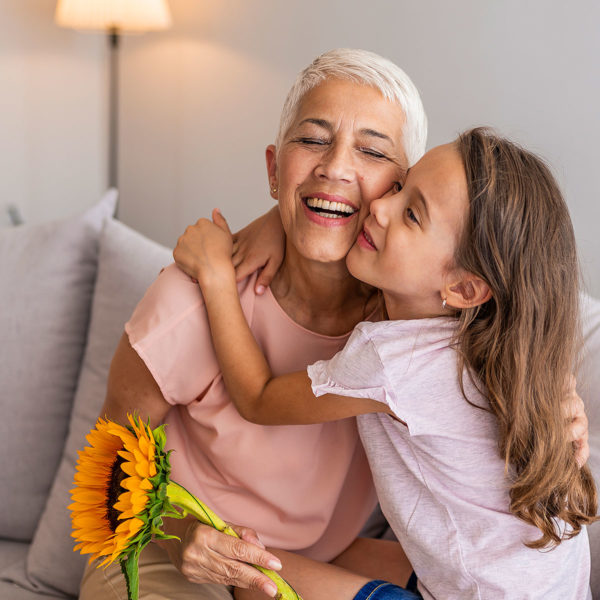Image of two people embracing one another on the couch