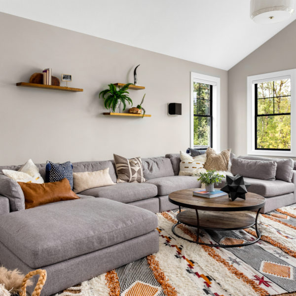 Image of a couch and table in a carpeted room.