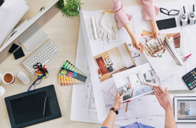 Image of a design table with various photos and designs on it.