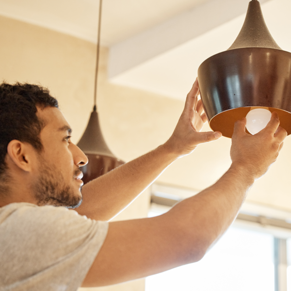 Man installing LED light bulb