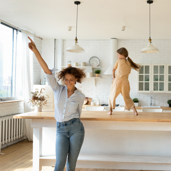 mom and daughter dancing in kitchen