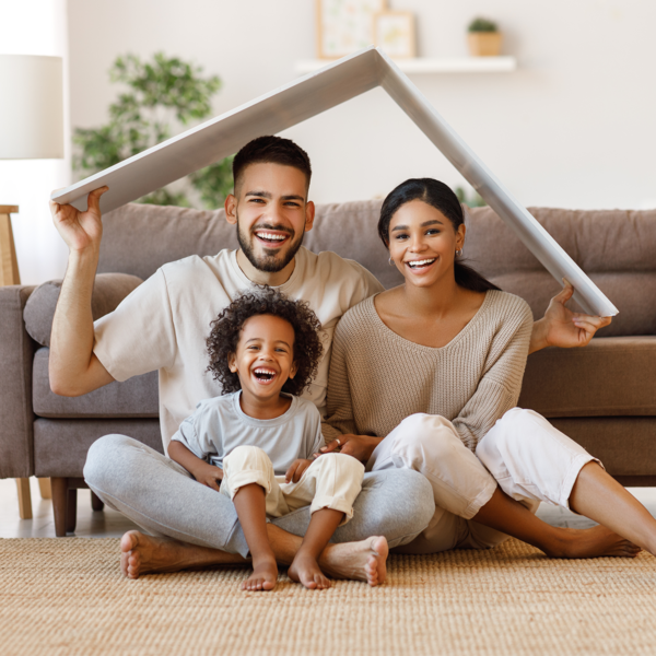 Father, mother and child holding a roof-like object over their heads
